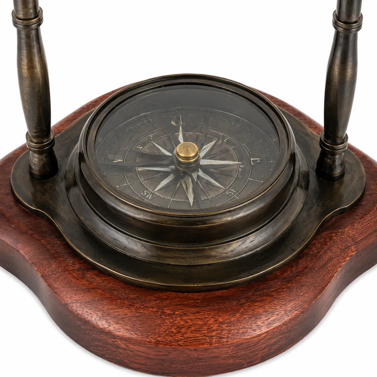 Close-up of glass-covered directional compass set in wooden base