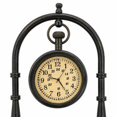 Close-up of antique brass desk clock face with black Arabic numerals