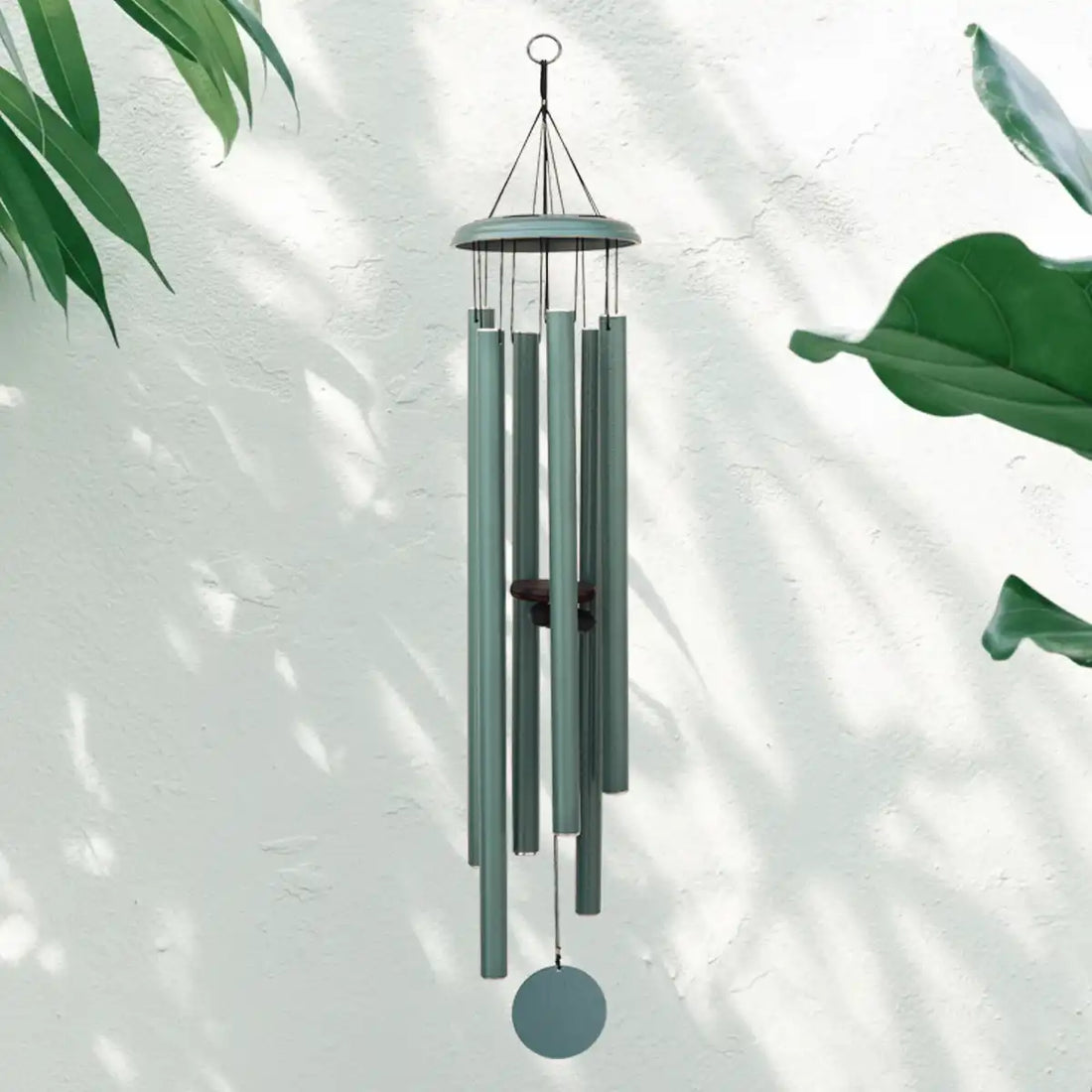 Turkish Green Corinthian Bells Wind Chime with leaves in the background