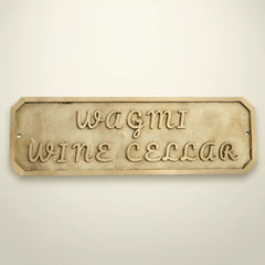 Decorative sign Custom brass name plate for door on a beige background
