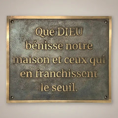 custom bronze plaque with engraved text on a plain background