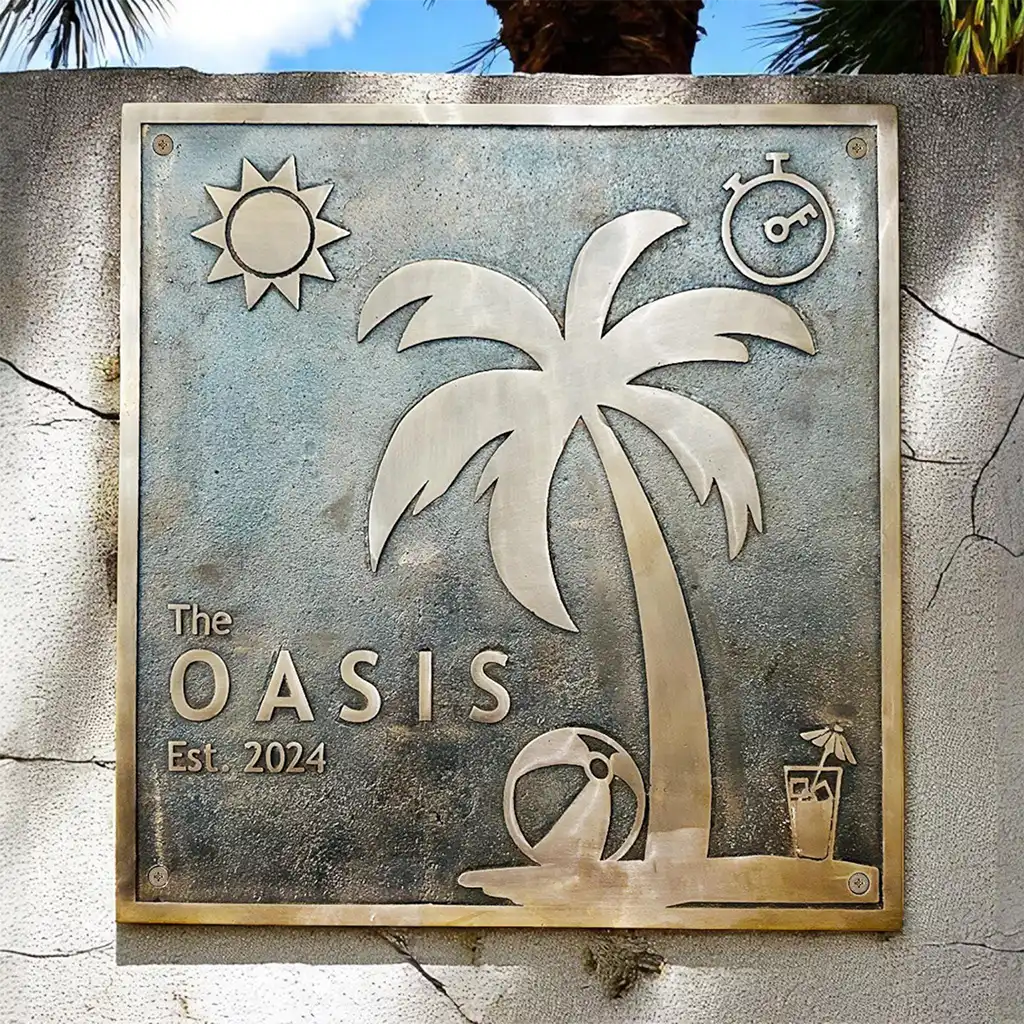 Bronze plaques for outdoors with palm tree design and 'The Oasis' text on a stone wall.