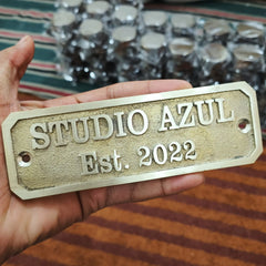 Close-up of engraved brass address plaque showing detailed craftsmanship