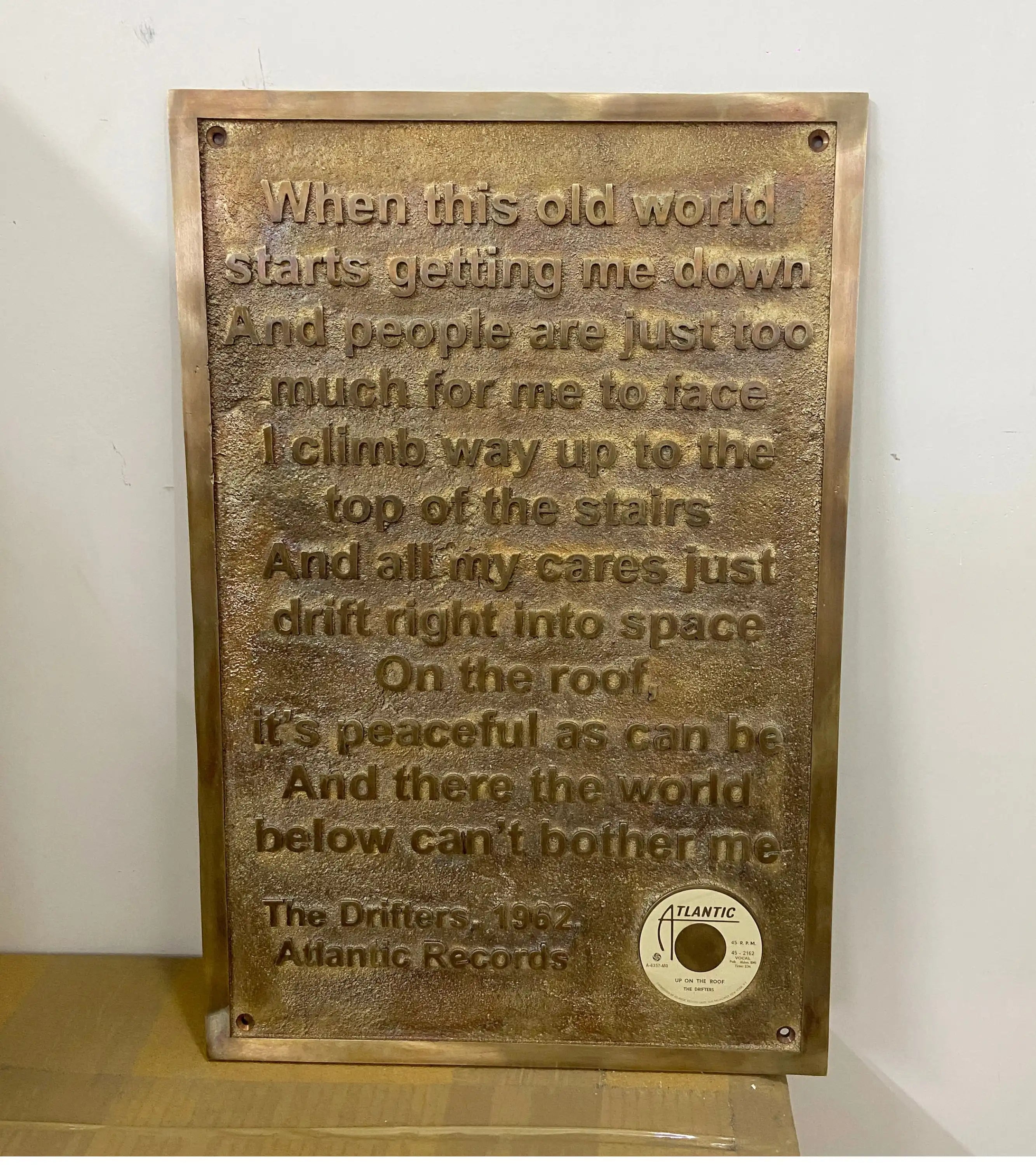 Bronze plaque with engraved text and Atlantic Records logo on a white background