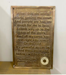 Bronze plaque with engraved text and Atlantic Records logo on a white background