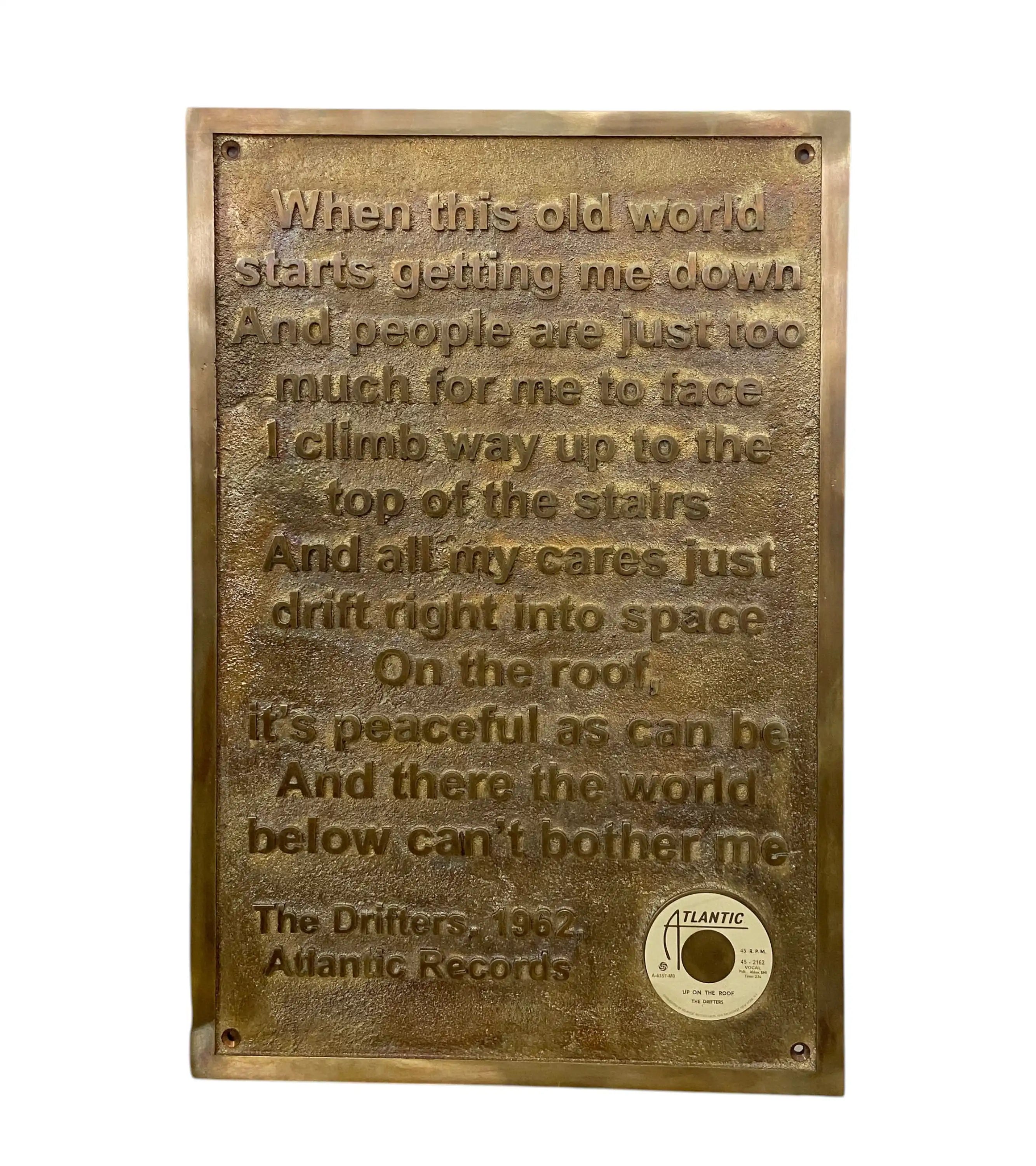 Bronze plaque with engraved text and Atlantic Records logo on a white background