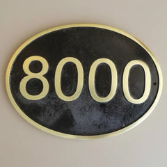 Oval-shaped house number sign—Custom brass door sign with engraved digits