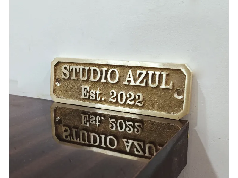 An elegant brass nameplate with engraved address and year