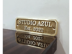 An elegant brass nameplate with engraved address and year
