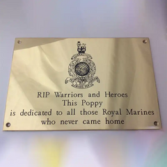 Brass memorial plaque with custom engraving dedicated to Royal Marines with text and emblem on a gold background