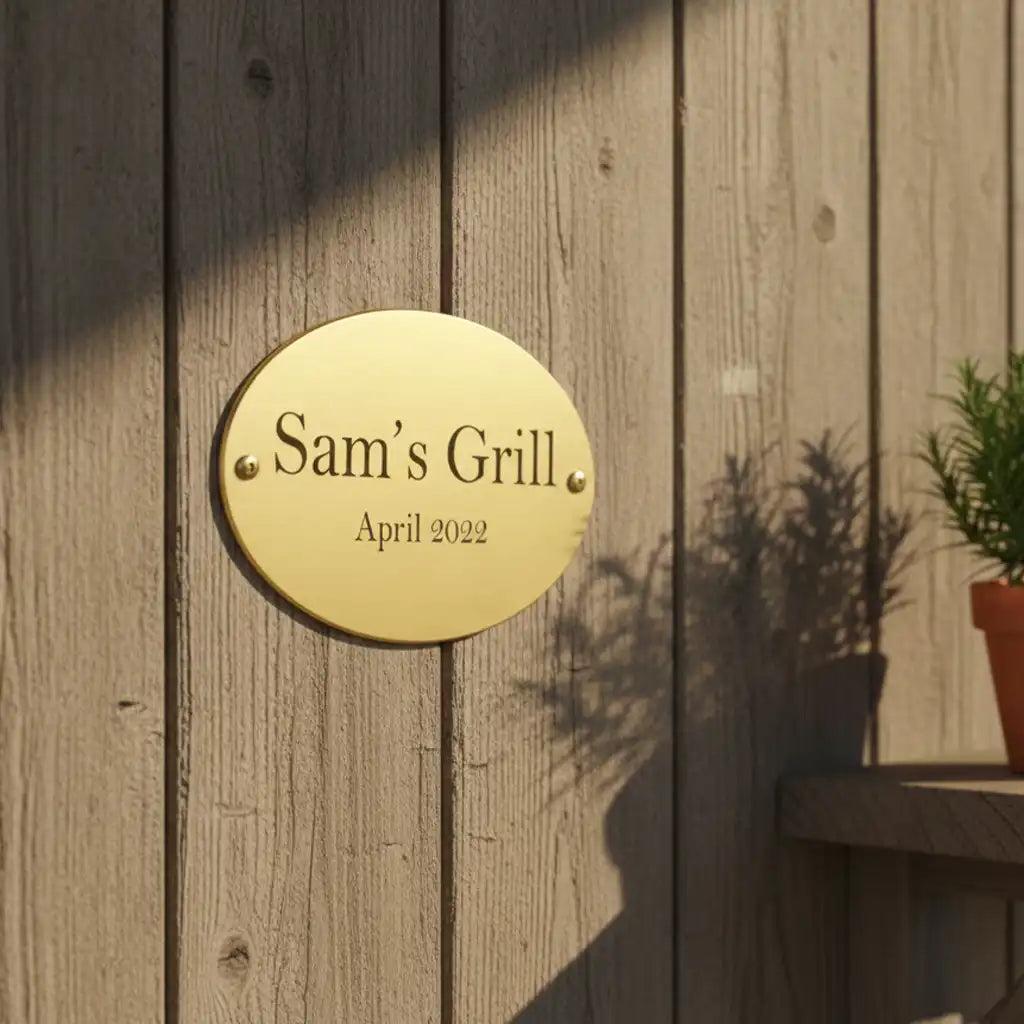 Engraved brass plate: Gold plaque with on a wooden wall