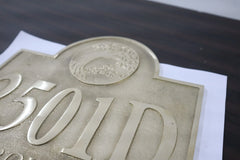 Metallic plaque with '501D' engraving on a dark surface