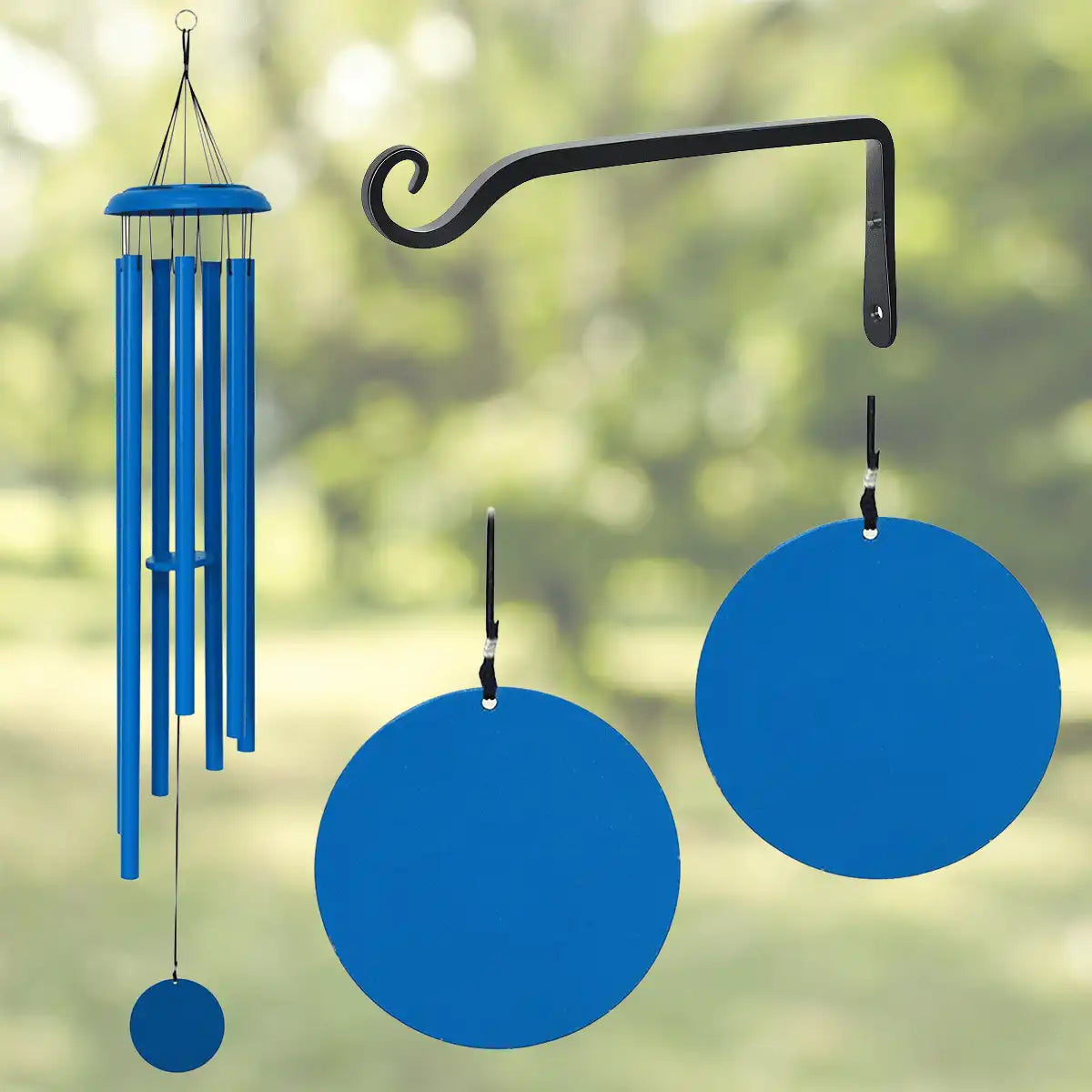 Blue wind chime with a black hook against a blurred green background