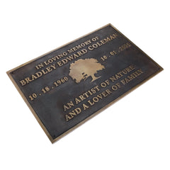 Brass Memorial plaque with engraved text and a tree silhouette on a white background