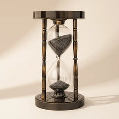 Sand timer with wooden casing on a beige background