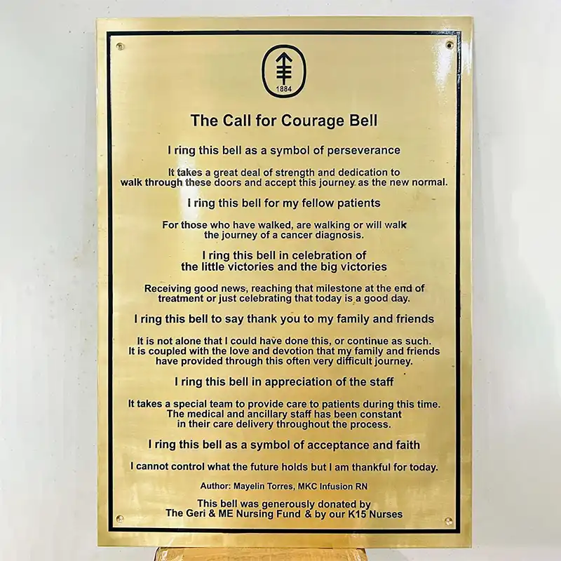 Brass plaque with engraved text on a white background