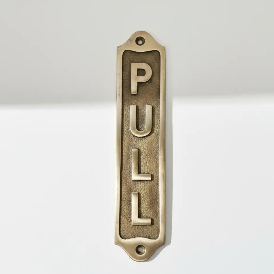 Solid Brass 'PULL' door sign | Door handle on a white background