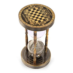 Hourglass timer with chessboard design on top, on a white background