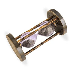 Hourglass with sand running through on a white background