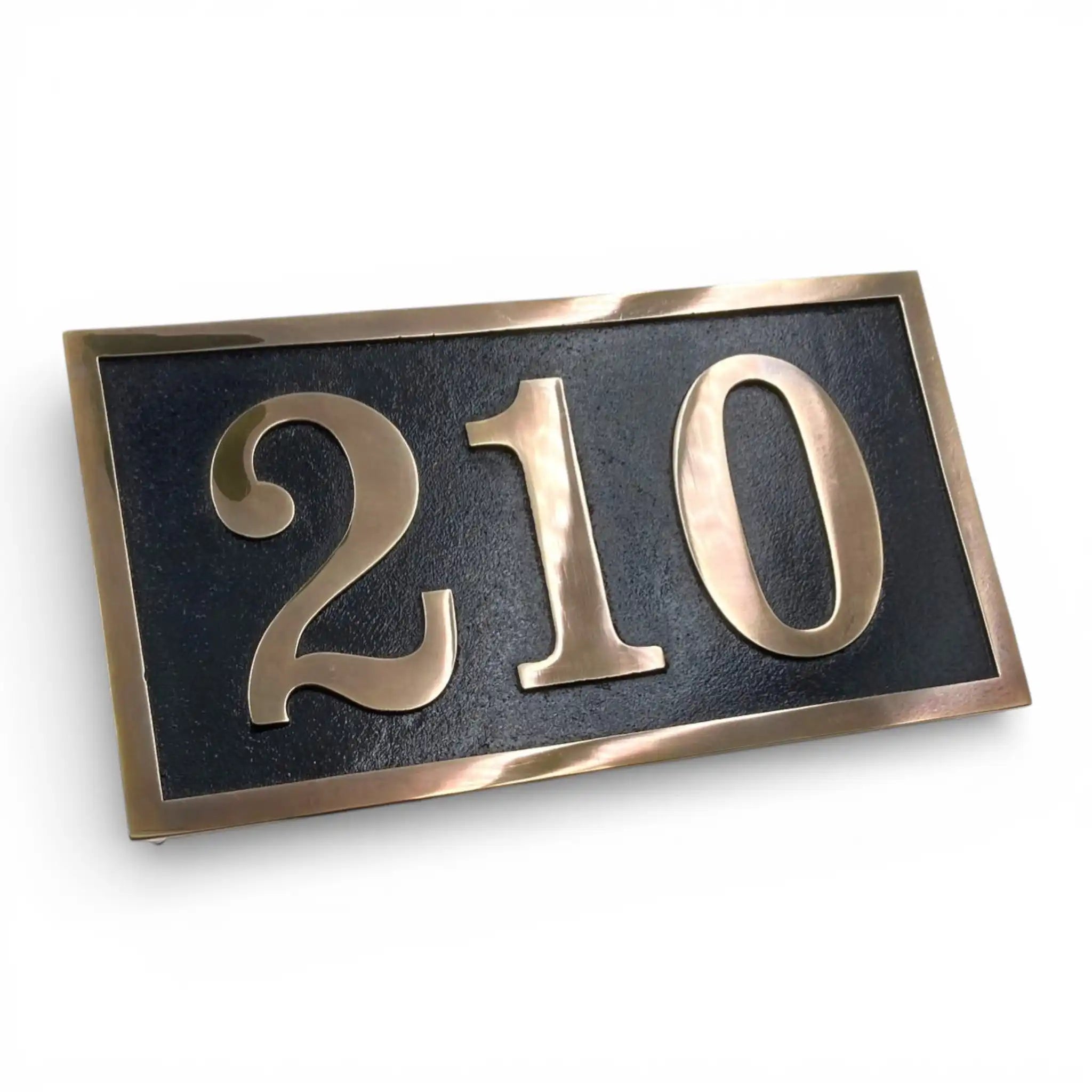 House number plate with '210' on a black background
