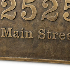 Brass oval house number plaque with precision engraved lettering