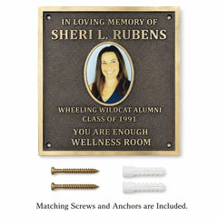 Bronze memorial plaque with engraved picture and personalized inscription displayed with mounting screws and wall anchors.