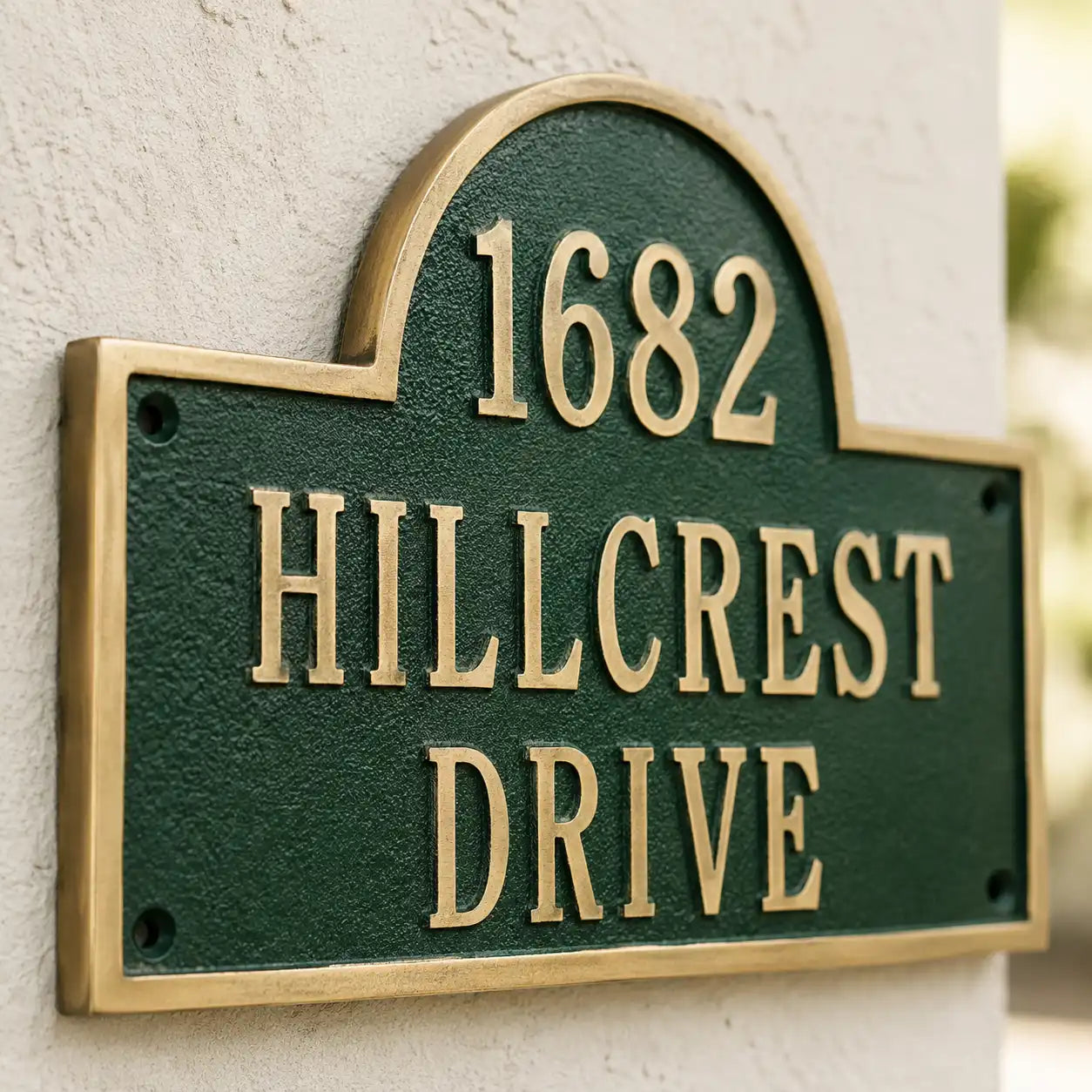 Engraved brass house number plaque with decorative top arch
