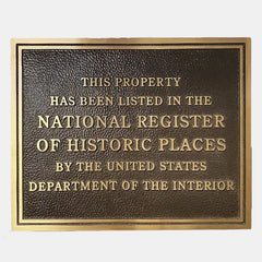 Bronze plaque with text about listing in the National Register of Historic Places on a white background