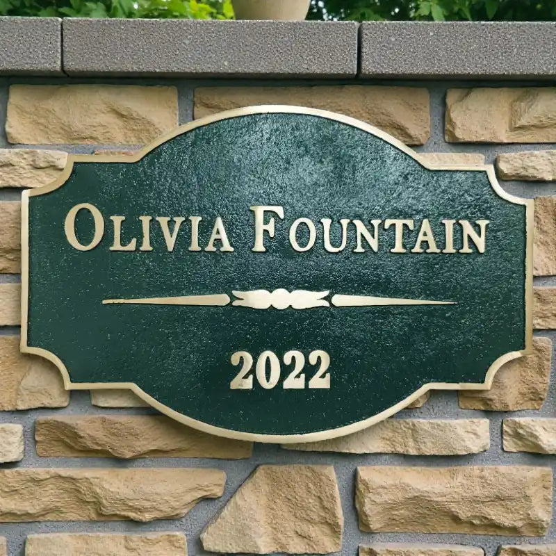 Brass address plaque nameplate on a stone wall background