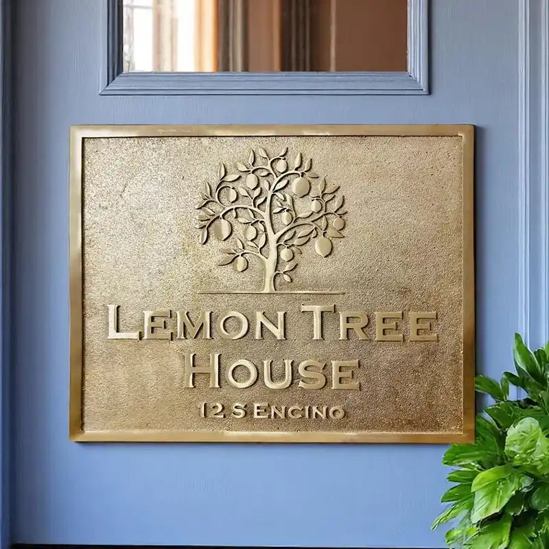 Personalized brass address plaque displayed on a home wall