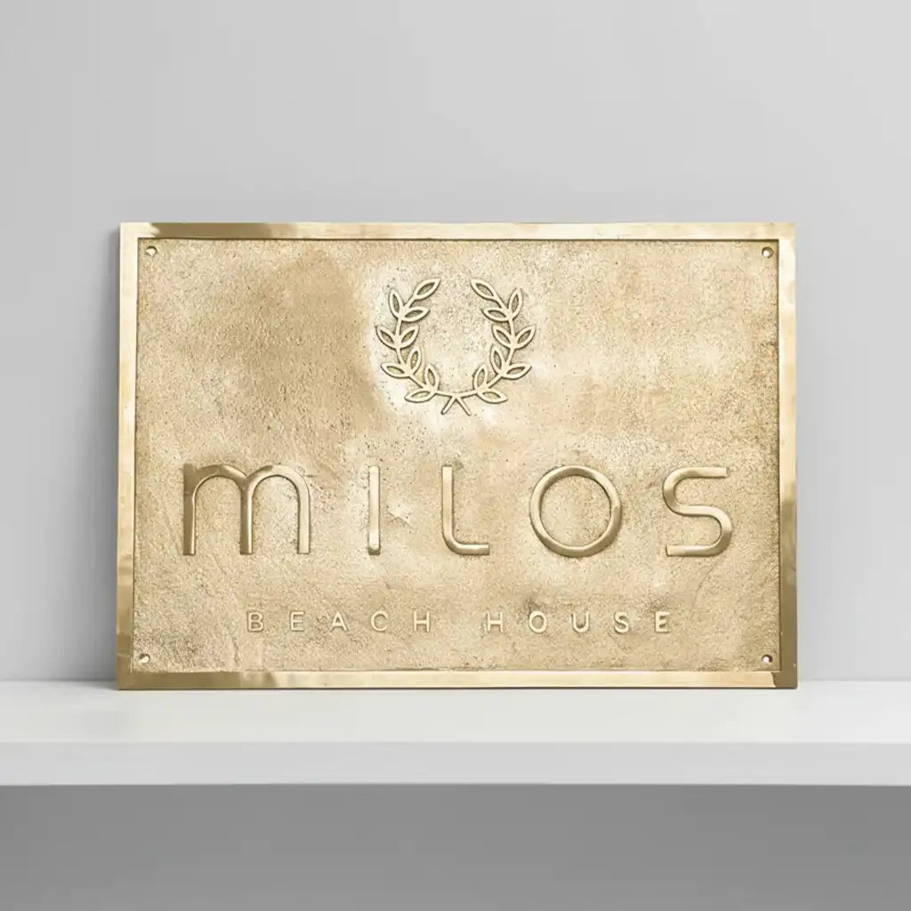 Brass Address Plaque – Custom Engraved Plaques in brass Finish on a gray background
