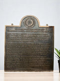 brass historical plaque Bronze plaque with engraved text on a white background