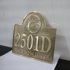 Bronze house number sign with '2501D' and 'Rainbow Drive' text on a white background