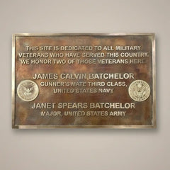 Bronze plaque dedicated to military veterans with engraved names and titles.