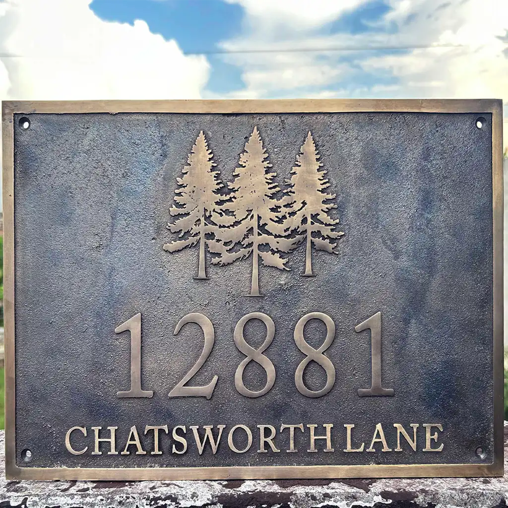 Personalized bronze address plaque, house address sign with trees and house number against a natural background