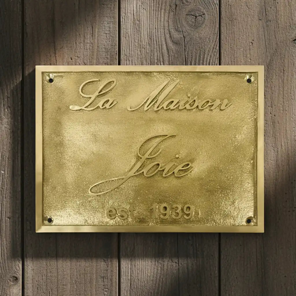 Engraved brass name plate | Gold plaque with on a wooden background