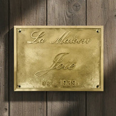 Engraved brass name plate | Gold plaque with on a wooden background
