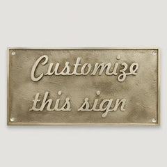 Brass sign with 'Customize this sign' text on a white background