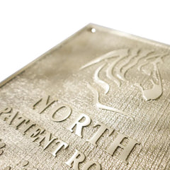 Close-up view Custom Brass Address Plaques: Engraved with Business Logos 