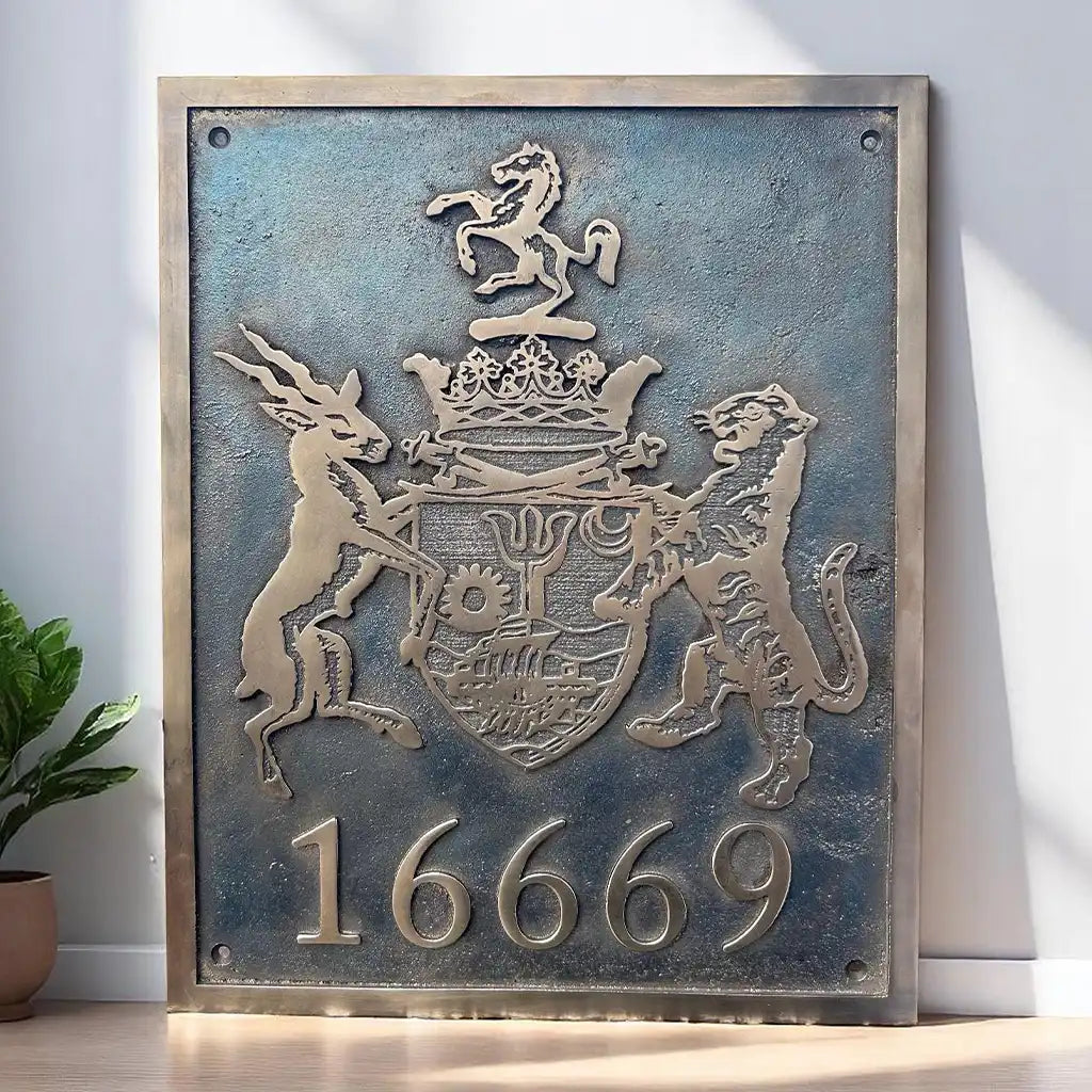 Cast bronze plaque with a coat of arms and numbers '16669' on a white wall.