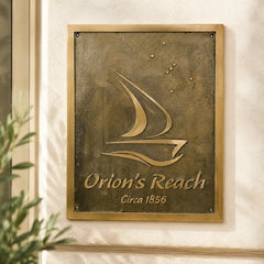 close-up of engraved bronze house plaque installed on an ivory wall