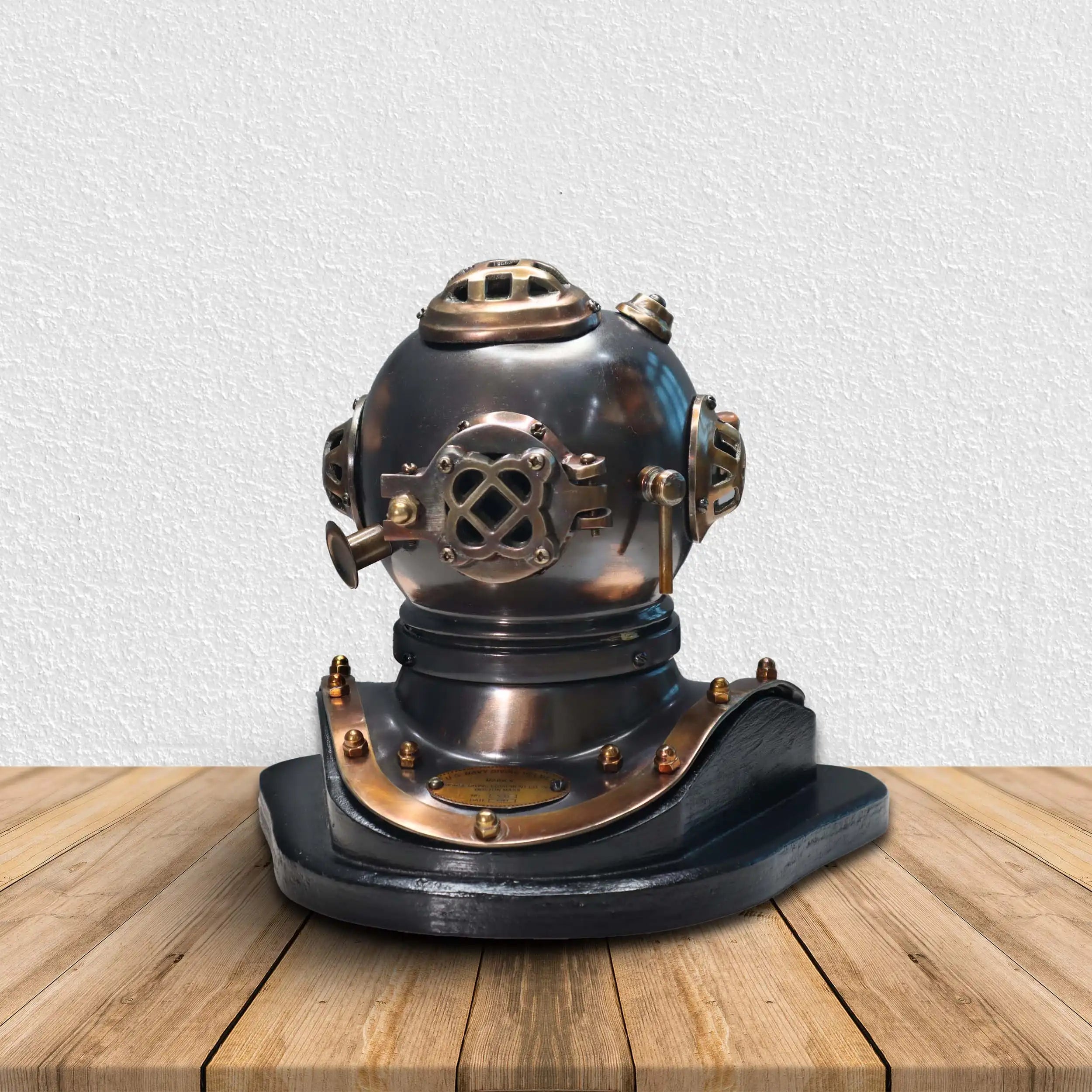 Vintage diving helmet on a wooden surface with a white background