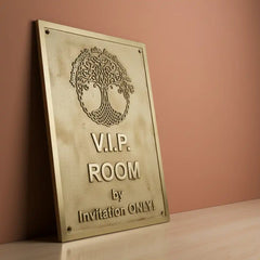 Handcrafted brass plaque personalized text on a pink background