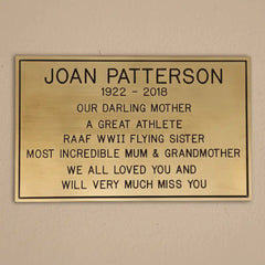 Custom brass remembrance plaque—memorial plaque on a beige wall