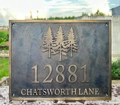 Bronze Plaques - Metal sign with tree design and text '12881 Chatsworth Lane' against a blurred outdoor background