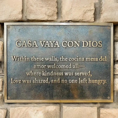 Bronze plaque with engraved text on a stone wall, custom bronze metal sign, custom bronze memorial plaque