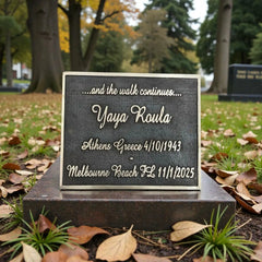 Memorial plaque with engraved text in a park setting