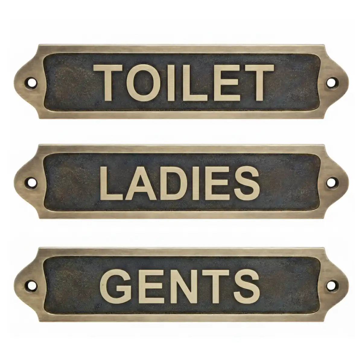 Three brass signs labeled 'TOILET', 'LADIES', and 'GENTS' on a white background.